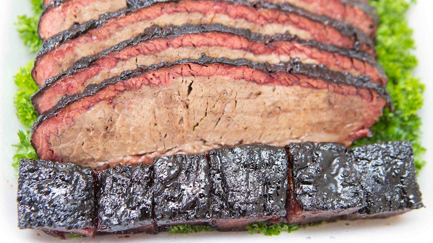 Thinly sliced brisket on a bed of lettuce.