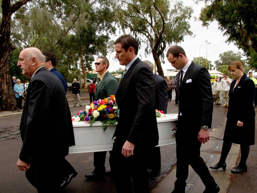 Pallbearers carry the casket of late mayor Joy Baluch at Port Augusta.