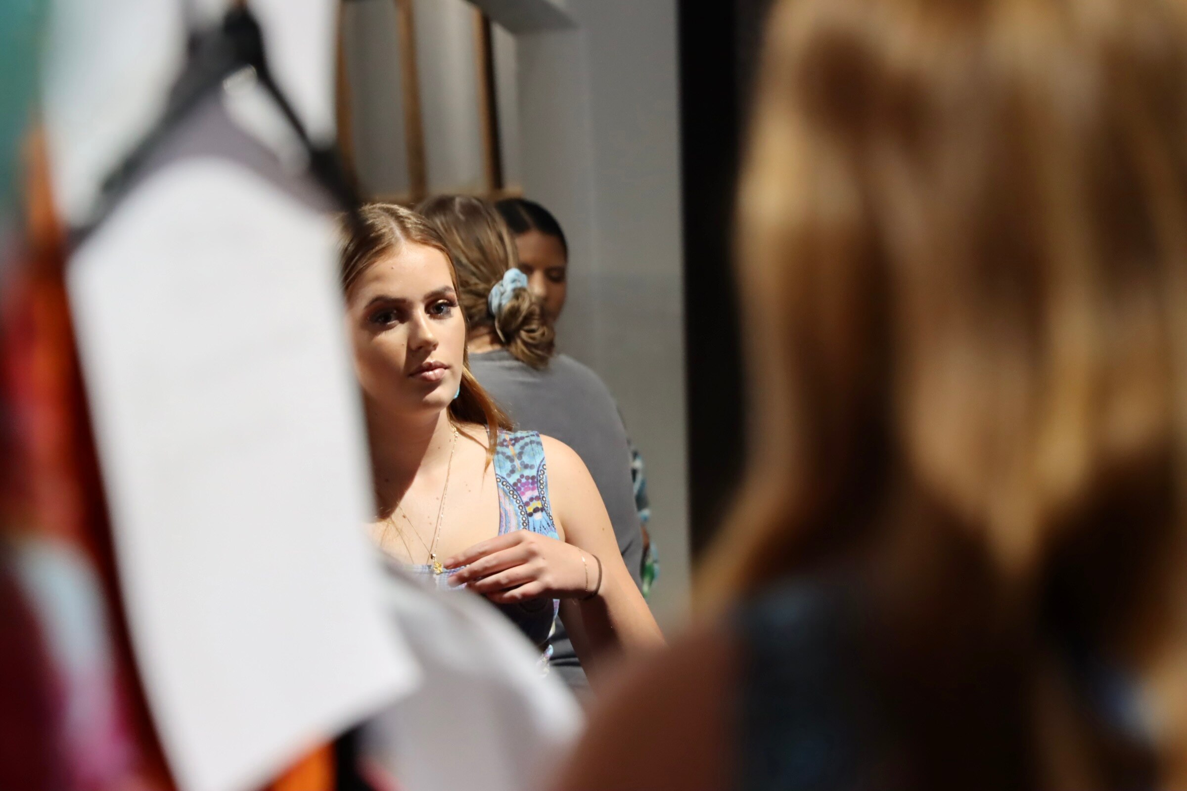 girl looking at herself in the mirror