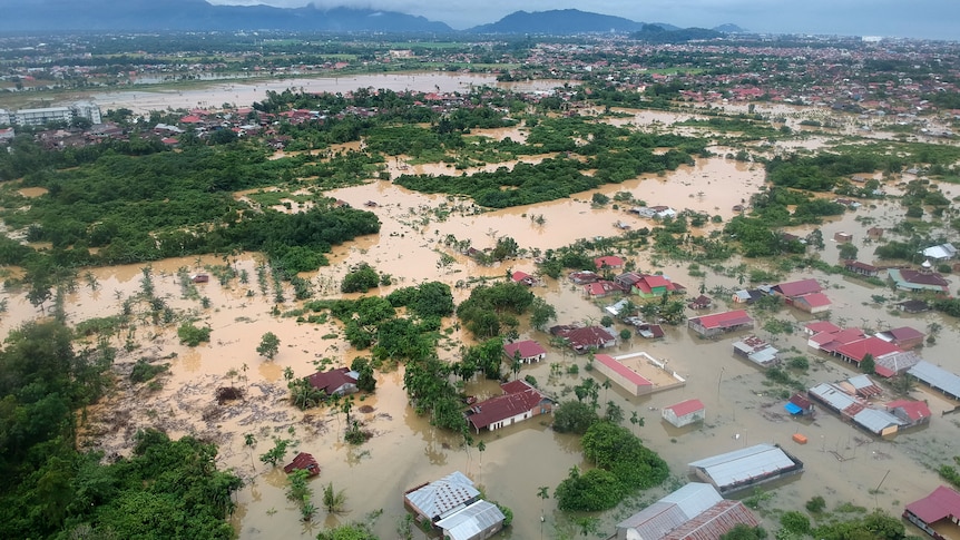 An aerial shot shows dozens of properties hit by floodwater