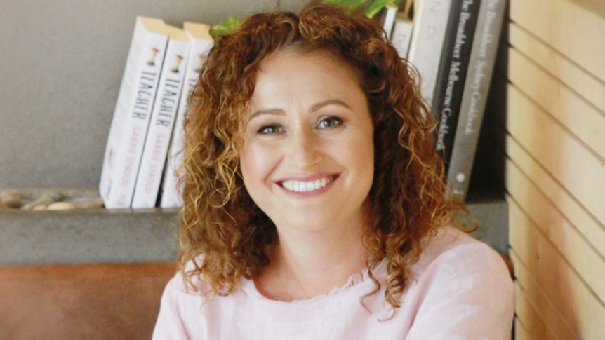 Author and teacher Gabrielle Stroud sitting in front of a bookshelf