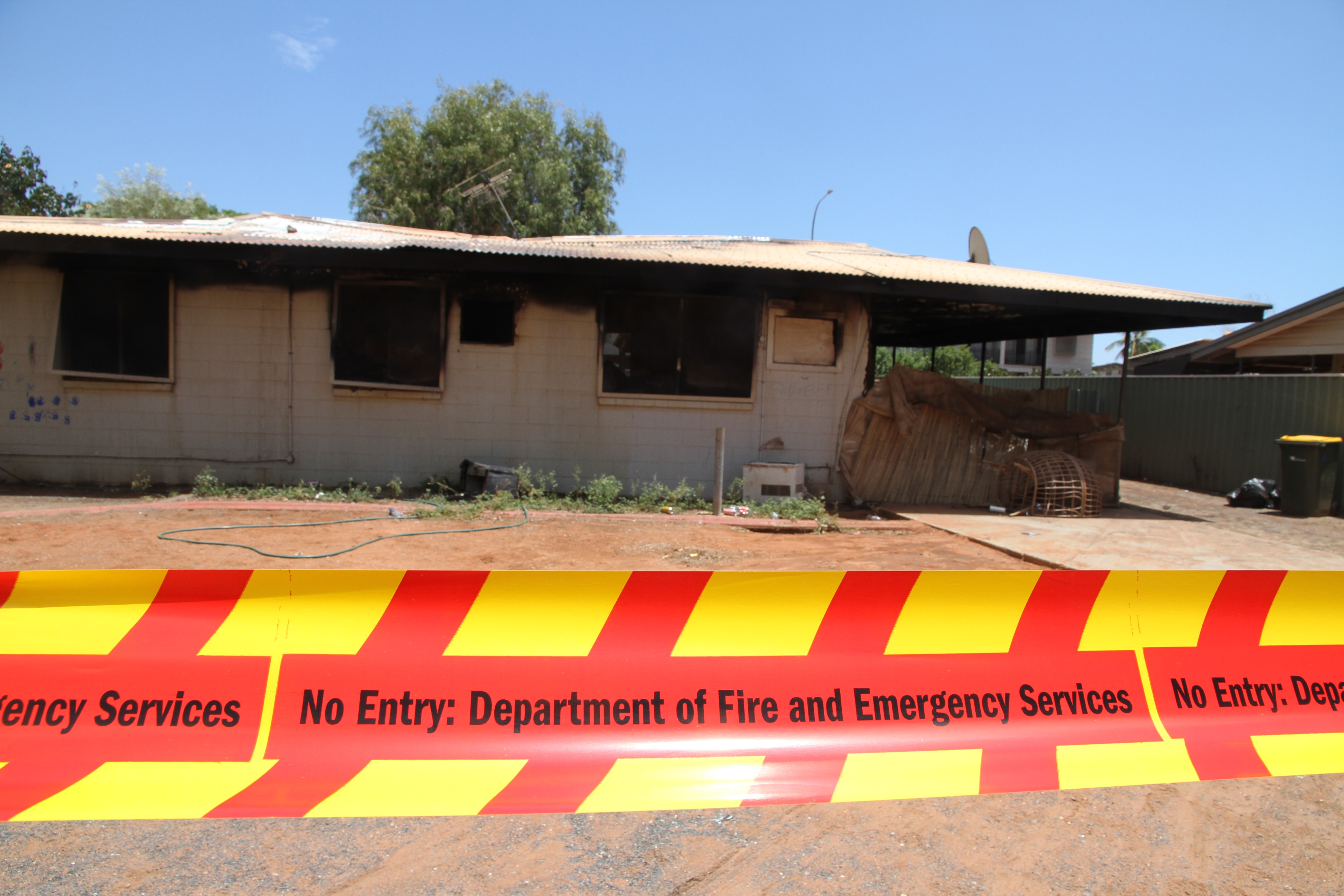 DFES tape across Mitchie Crescent house after a fire