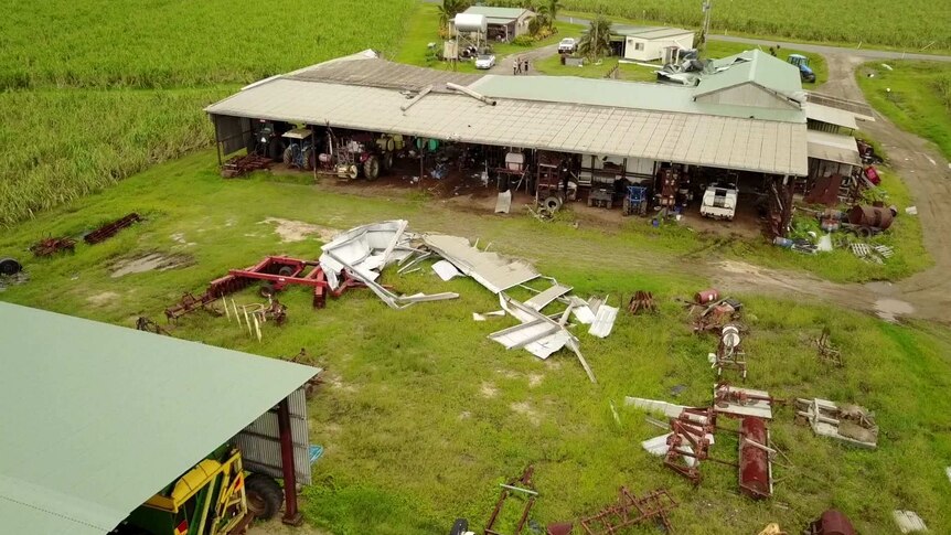 Aerial shot of sheds with debris across the farm.