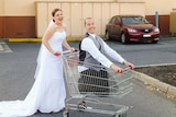 Kelly and her husband Justin in a supermarket shopping trolley