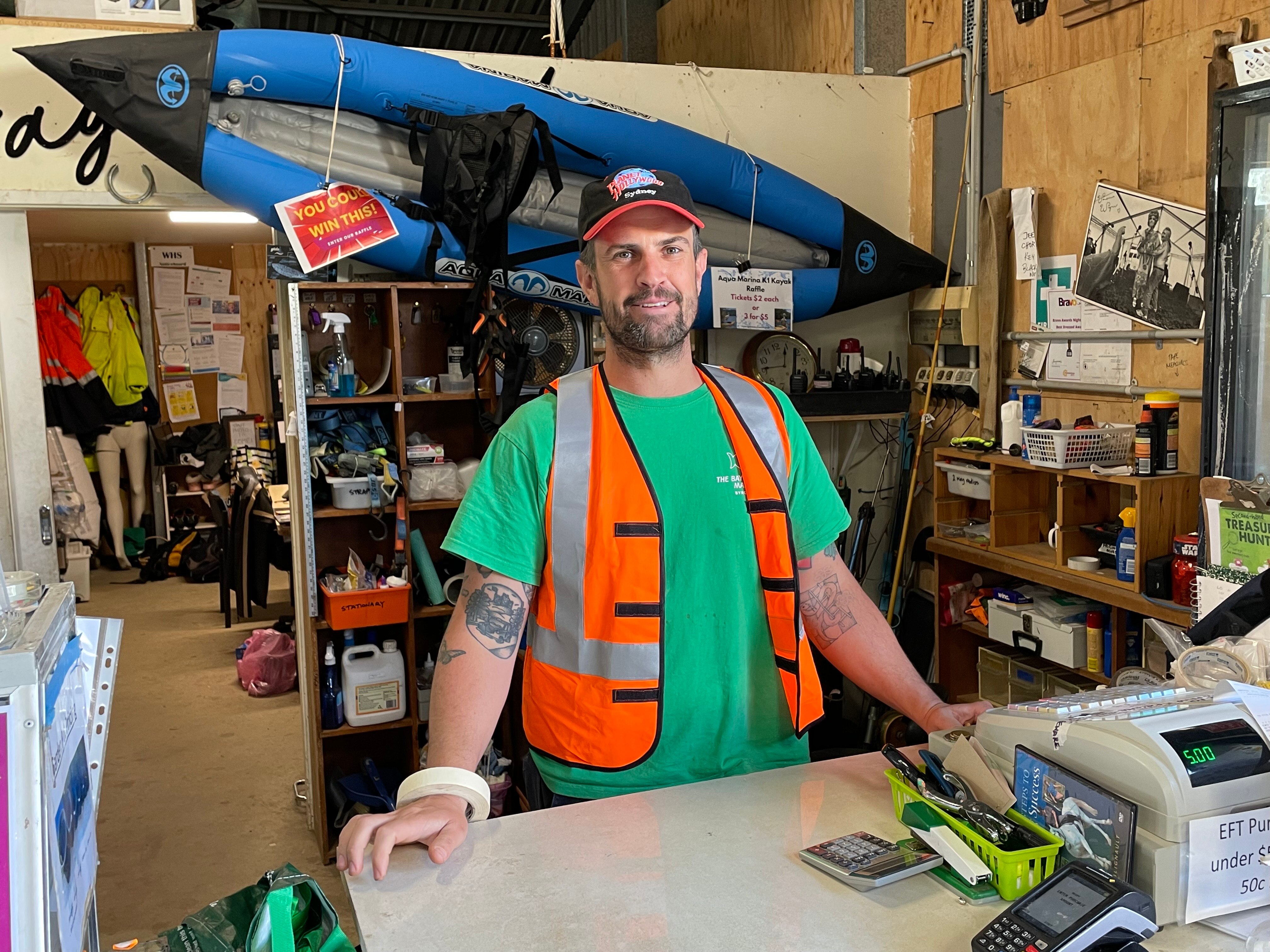 Man standing at counter at salvage facility.