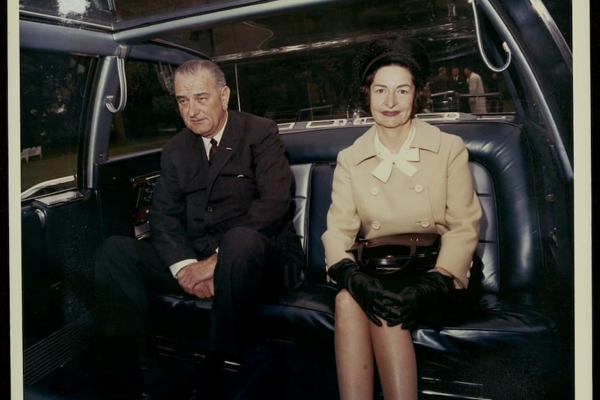 Lyndon B Johnson and his wife 'Lady Bird' sit inside the limousine.
