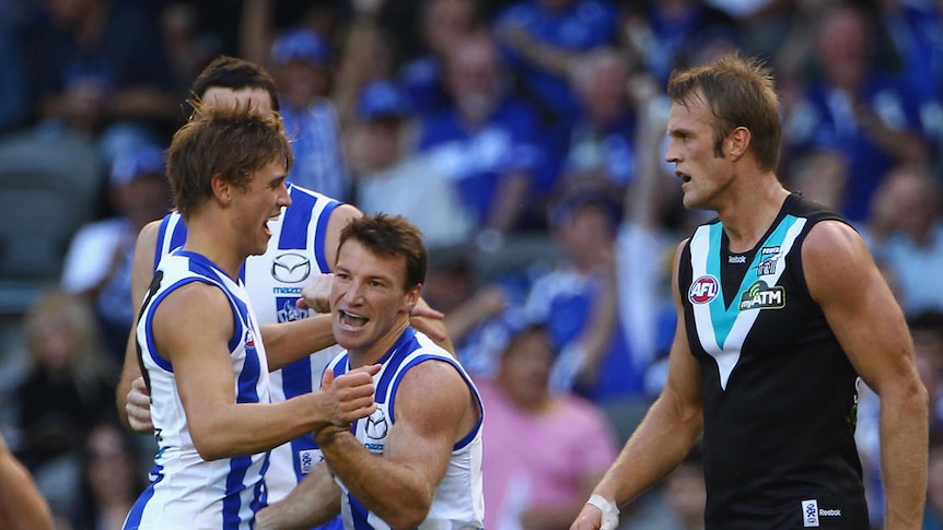 Drought broken ... North Melbourne skipper Brent Harvey celebrates kicking one in his side's first win of 2011.
