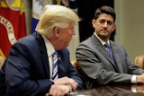 Speaker of the House Paul Ryan listens as U.S. President Donald Trump speaks