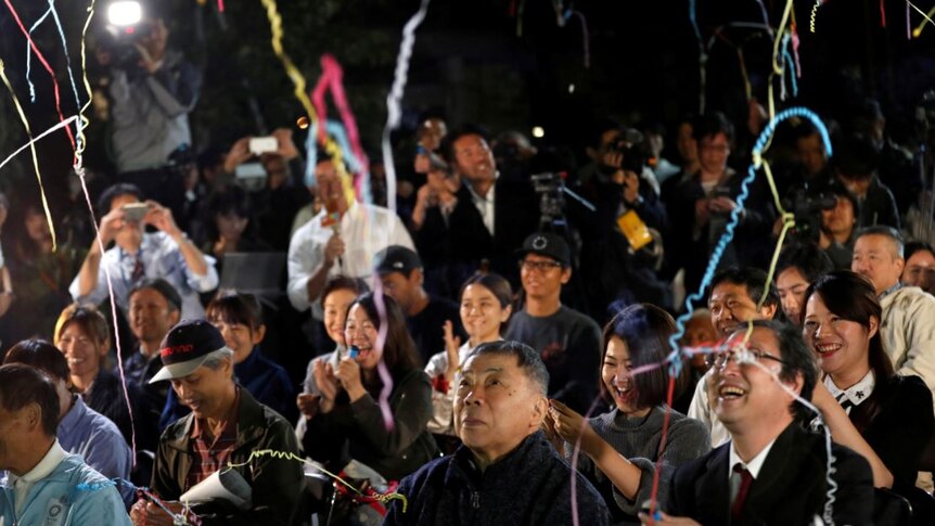 Fans of the Japanese writer Haruki Murakami celebrate after they heard that Japanese-born Kazuo Ishiguro won.