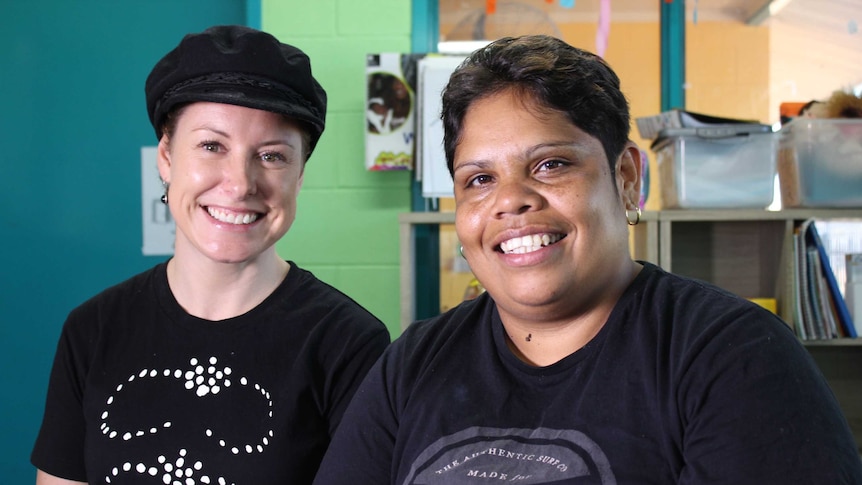 Two women sit next to each other.