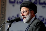 Close up of Iranian president speaking into microphone.