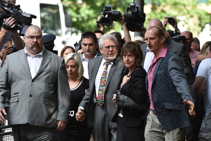Rolf Harris arrives with daughter Bindi and niece Jenny at Southwark Crown Court.