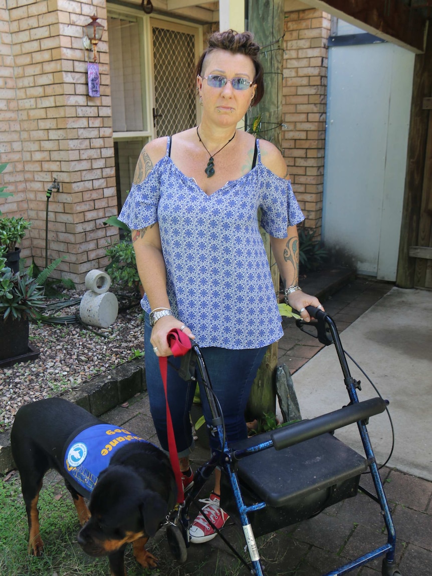 Rachael Baker with assistance dog and walker.