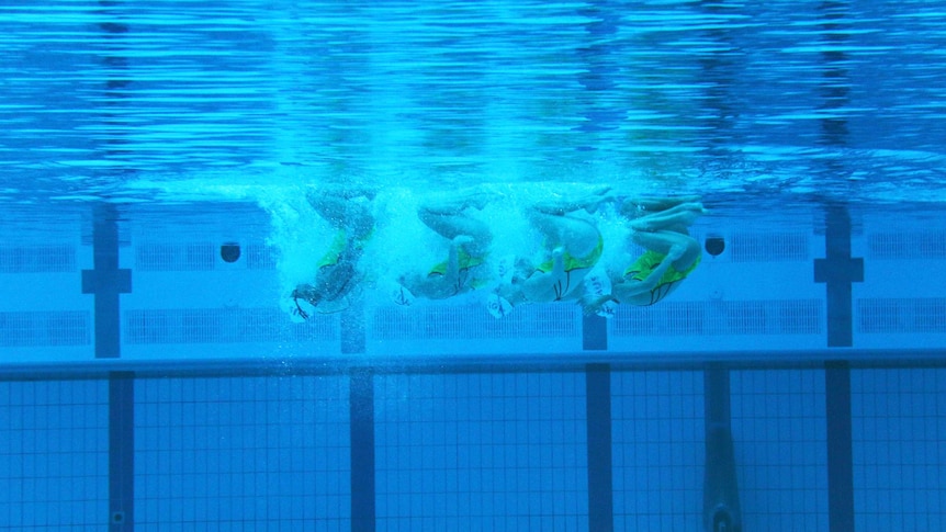 View from underwater of the synchronised swimming team.