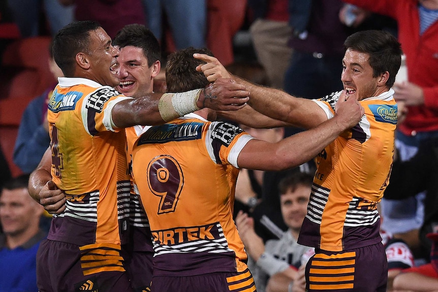 Brisbane celebrates a try in the NRL preliminary final against the Roosters