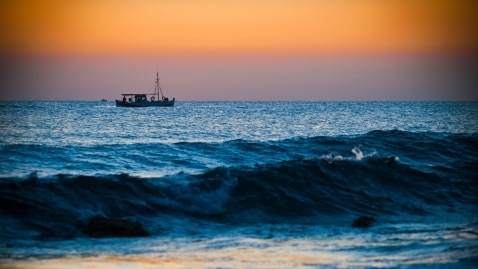 A small boat on the ocean at sunrise. (Thinkstock: iStockphoto)