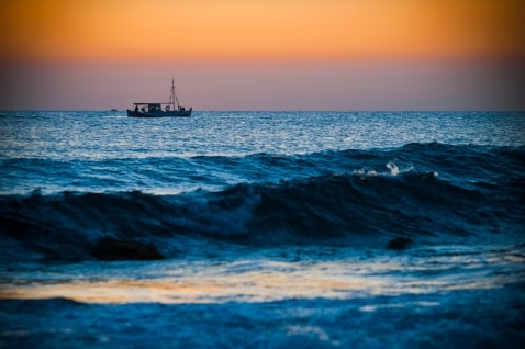 A small boat on the ocean at sunrise. (Thinkstock: iStockphoto)