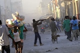 A man points a gun at a crowd in downtown Port-au-Prince in Haiti