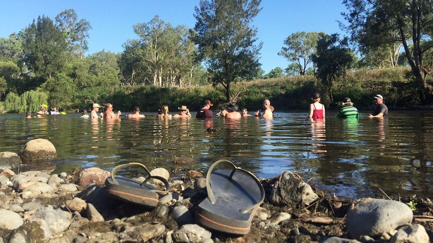 Road Boss Rally Reunion drivers cool down at a creek near Warwick in southern Qld
