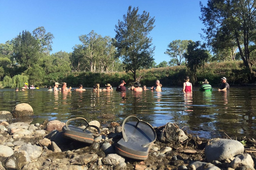 Road Boss Rally Reunion drivers cool down at a creek near Warwick in southern Qld