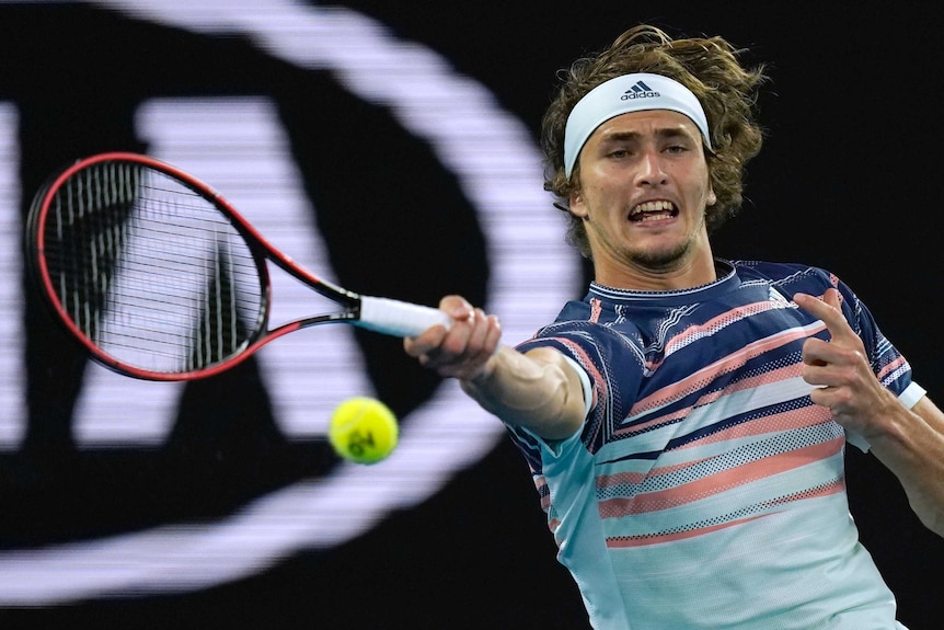 A tennis player extends his racquet out to hit a forehand return at the Australian Open.