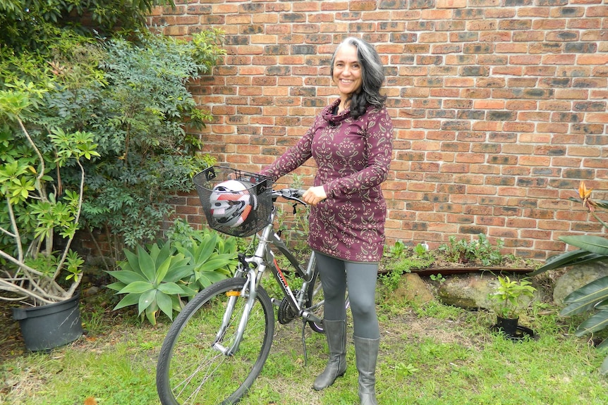 Anna standing next to her bike