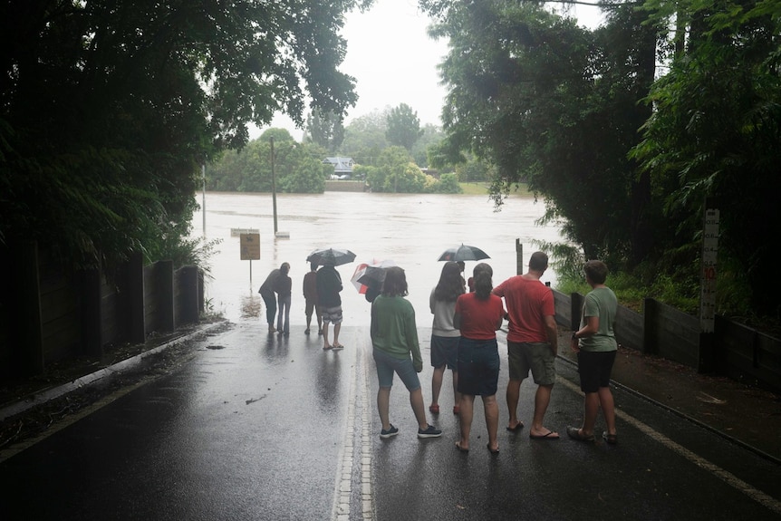 People watch flood waters