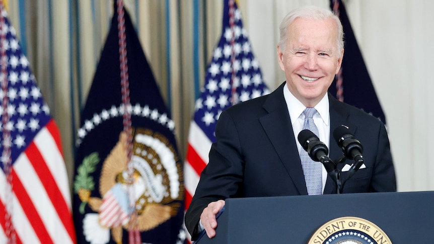 Joe Biden standing behind a lectern.