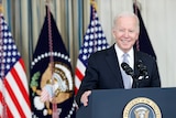 Joe Biden standing behind a lectern.