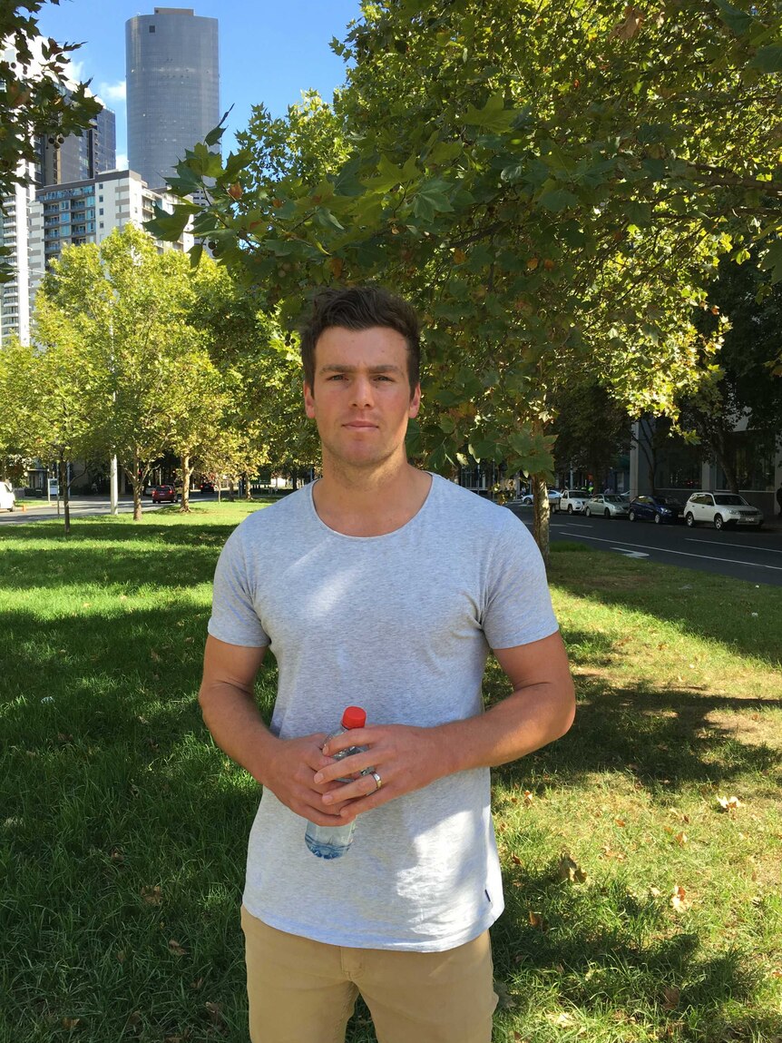 Former Essendon player Brent Prismall stands in a inner-city park.
