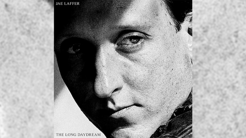 The cover of The Long Daydream is a black and white close-up of Jae Laffer's face