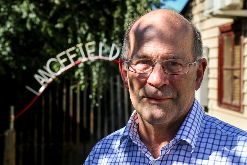 Dr Paul Carter stands in front of a Lancefield sign.