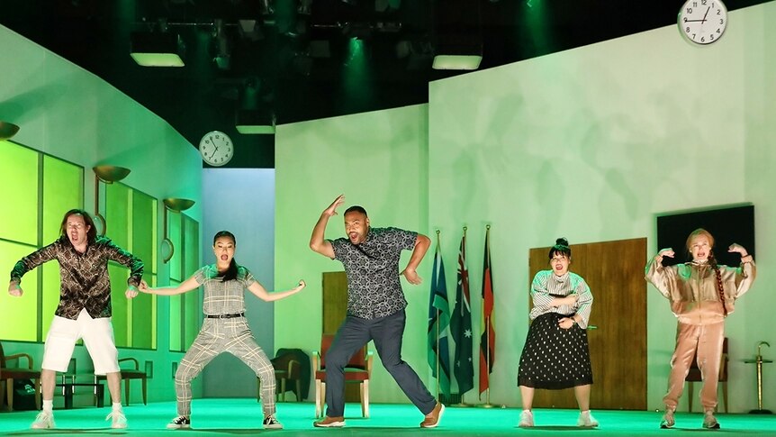 Colour production still of the How to Rule the World cast on stage in an office space in the 2019 at Sydney Theatre Company.