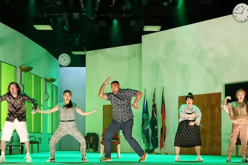 Colour production still of the How to Rule the World cast on stage in an office space in the 2019 at Sydney Theatre Company.