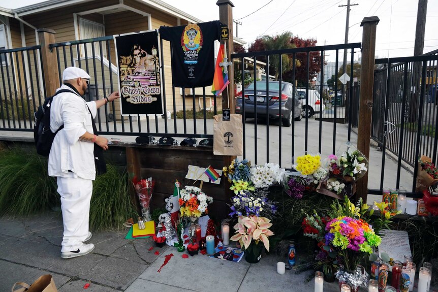 A man visits a memorial for victims of a warehouse fire in Oakland, California.