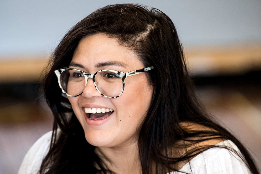 Playwright and actress Nakkiah Lui laughs.