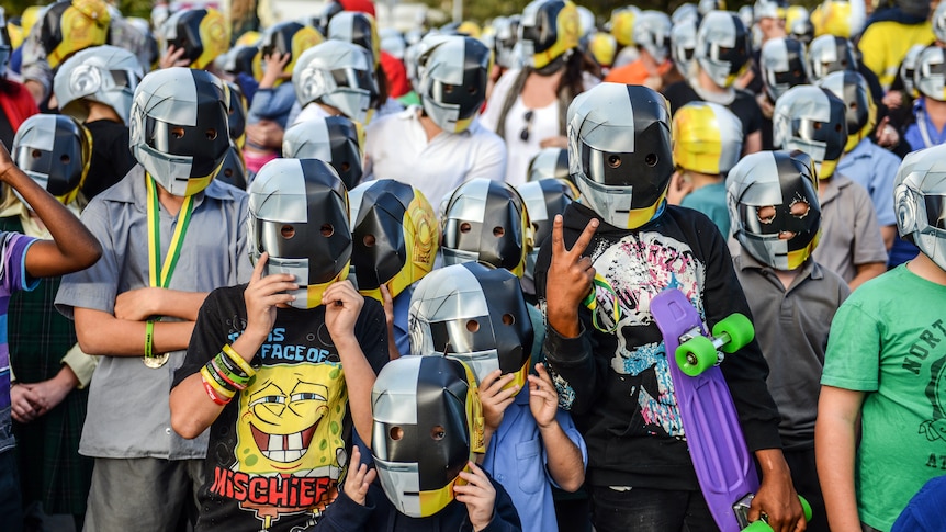 Wee Waa children gather en masse in town wearing matching cardboard Daft Punk robot masks