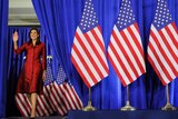 Nikki Haley walks on stage smiling and waving in South Carolina.