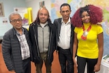 Mohammed, Abas, Berhan and Katinda standing side by side and smiling at the camera.