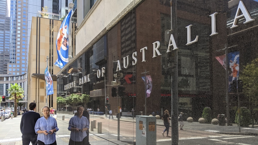 A woman and man walk past the Reserve Bank of Australia's headquarters in Sydney.