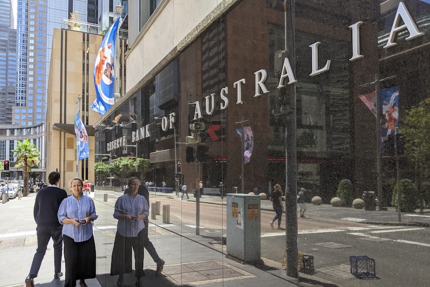 A woman and man walk past the Reserve Bank of Australia's headquarters in Sydney.