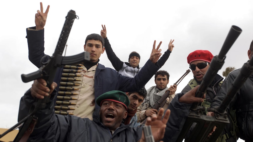 Libyan anti-regime protesters show machineguns and ammunition