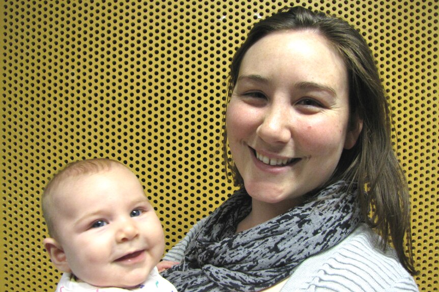 Mum Madeleine holds baby Penelope in her arms.