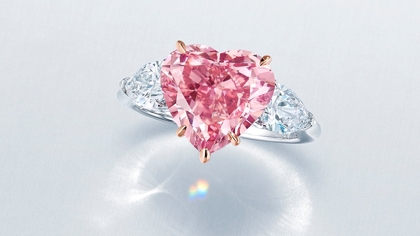 A ring featuring a large pink diamond in the shape of a love heart.