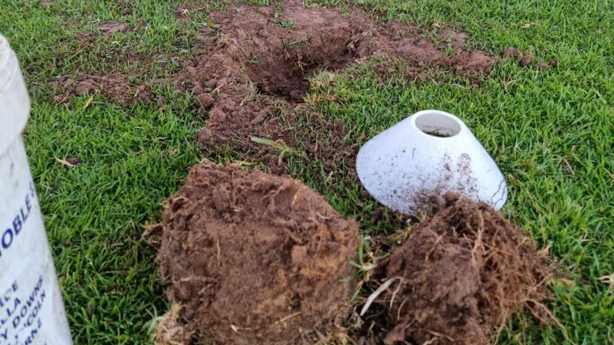 A hole in an oval with a marker next to it