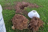 A hole in an oval with a marker next to it