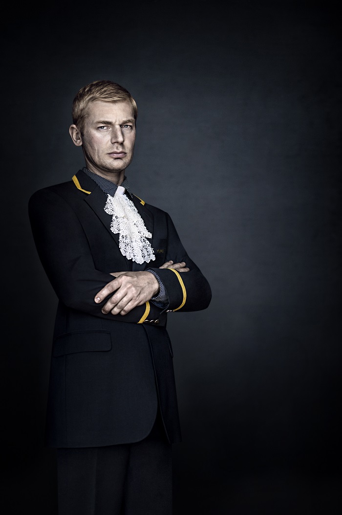 A portrait photograph of a New York City doormen in his uniform.