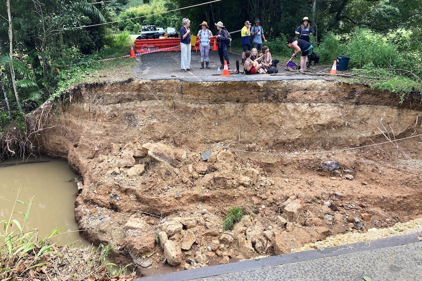 A massive section of road missing exposing the ground underneath