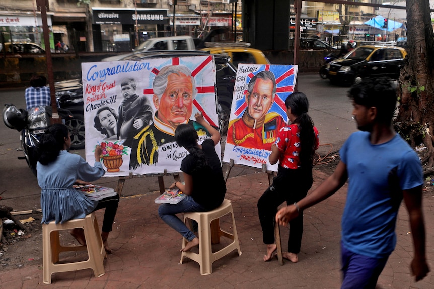 kids sit on plastic stools in the street painting portraits of royals