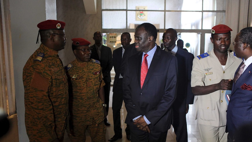 Burkina Faso's interim president Michel Kafando speaks with army chief General Pingrenoma Zagre